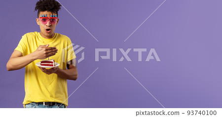 Celebration, party and holidays concept. Portrait of happy funny, enthusiastic young man celebrating birthday, protect lit candle on b-day cake from wind, making wish, smiling cheerful Celebration, party and holidays concept. Portrait of happy funny, enthusiastic young man celebrating birthday, protect lit candle on b-day cake from wind, making wish, smiling cheerful 93740100