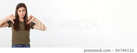 Image of resentful woman with long dark hair showing thumbs down isolated over gray background. Image of resentful woman with long dark hair showing thumbs down isolated over gray background. 93740110