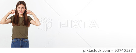 Closeup portrait of a young angry woman covering her ears, stop making that loud noise it's giving me a headache, isolated on white background. 93740187