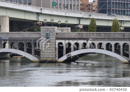 Urban city scenery with river, arch bridge, highway and buildings Urban city scenery with river, arch bridge, highway and buildings 93740430
