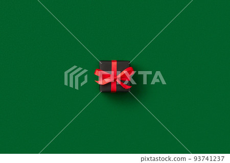 Christmas celebration concept. Gift on green background Christmas celebration concept. Gift on green background 93741237