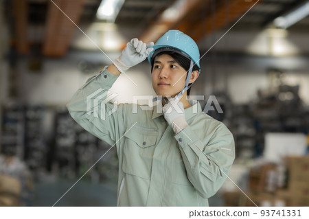 A young man working on clothes 93741331