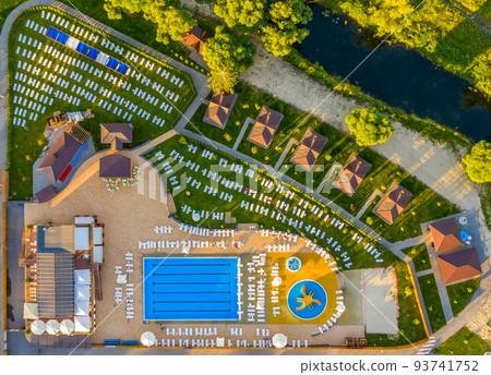 Aerial photo of a deserted recreation area with a pool and sun beds 93741752