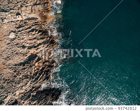 Aerial view of sea waves and fantastic Rocky coast, above view. 93742812