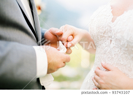 Groom holding bride hand. Close-up Groom holding bride hand. Close-up 93743107
