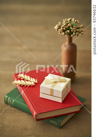 A gift box placed on top of an old book 93746632