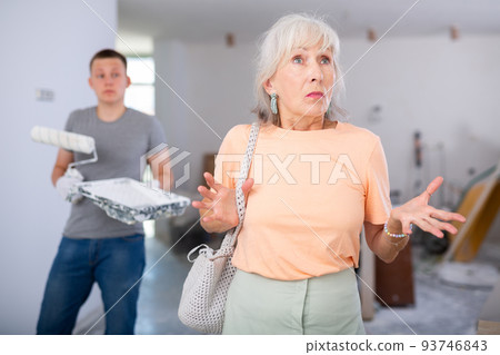 Woman dissatisfied with progress of repair works Woman dissatisfied with progress of repair works 93746843