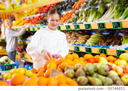 Portrait of teenage girl customer buying sweet oranges at shop Portrait of teenage girl customer buying sweet oranges at shop 93746851