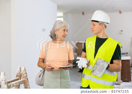 Woman talking with teenager on construction site Woman talking with teenager on construction site 93747235