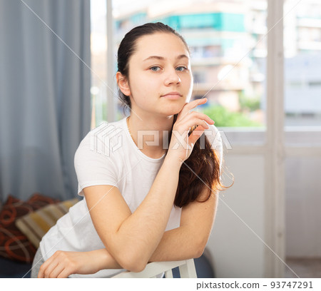 Young cheerful woman posing in living room Young cheerful woman posing in living room 93747291
