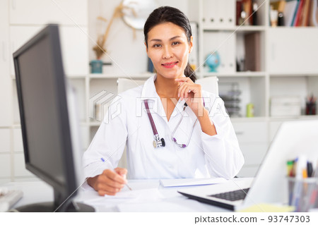 Portrait of female doctor in hospital interior 93747303