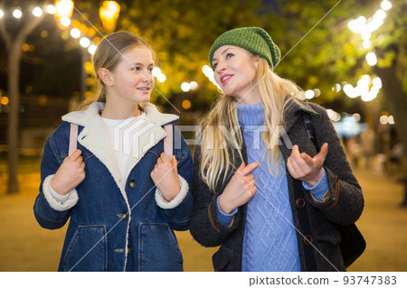 Portrait of mother with daughter at christmas street fair 93747383