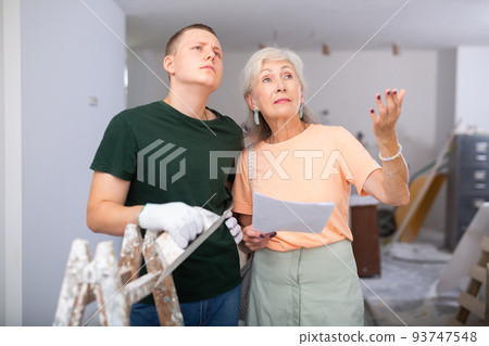 Woman talking with teenager on construction site 93747548