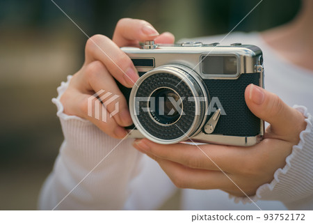 A woman with a film camera A woman with a film camera 93752172