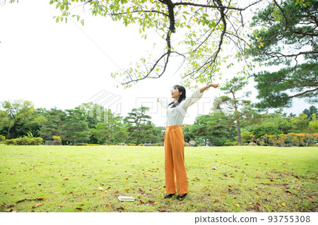 A woman taking a deep breath in the park Relax 93755308
