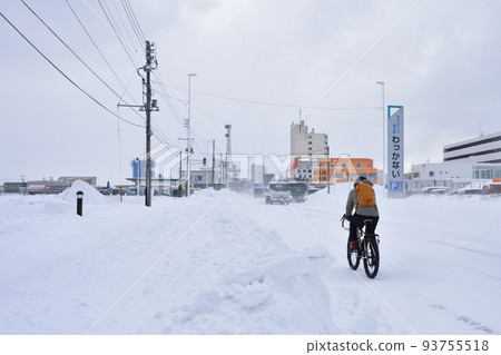 Bicycle riding on snowy road Bicycle riding on snowy road 93755518