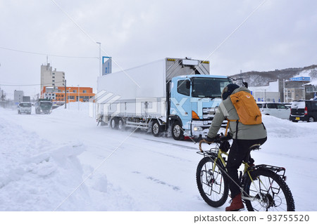 Bicycle riding on snowy road Bicycle riding on snowy road 93755520