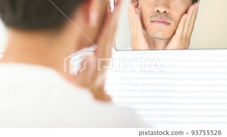 A man's hand touching his cheek with both hands Men's beauty image 93755526