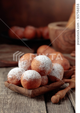 Cottage cheese doughnuts sprinkled with sugar powder. 93756858