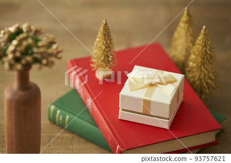 Christmas presents and miniature Christmas tree placed in the book 93757621