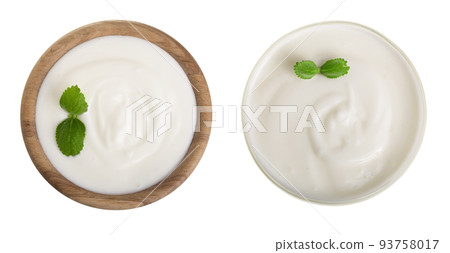yogurt in a wooden bowl with mint leaf isolated on white background top view 93758017