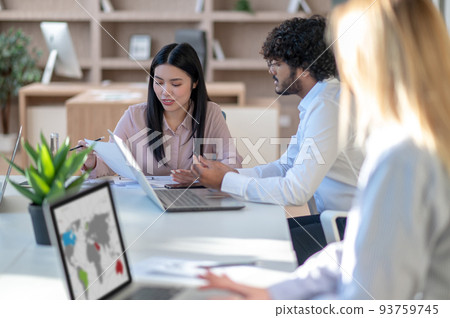 People working in the office and looking involved People working in the office and looking involved 93759745