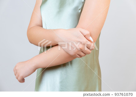 young woman experiencing pain in elbow joint 93761070
