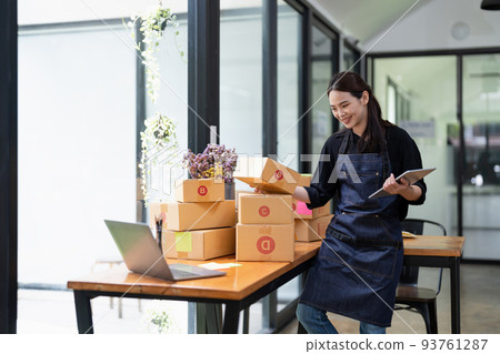 Young attractive asian woman owner startup business with box at home prepare parcel delivery in sme supply chain, procurement concept. 93761287