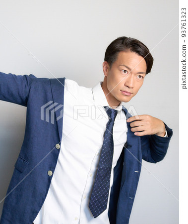 一個商人，他把手伸開，把袖子穿過夾克 93761323