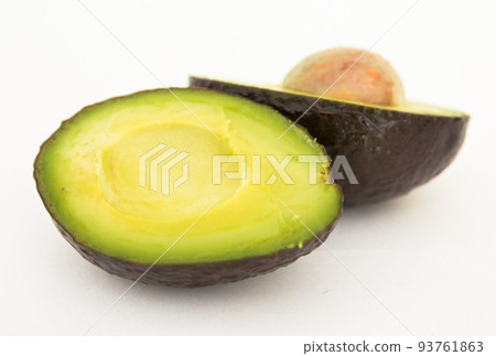 halved avocado with bone on white background halved avocado with bone on white background 93761863
