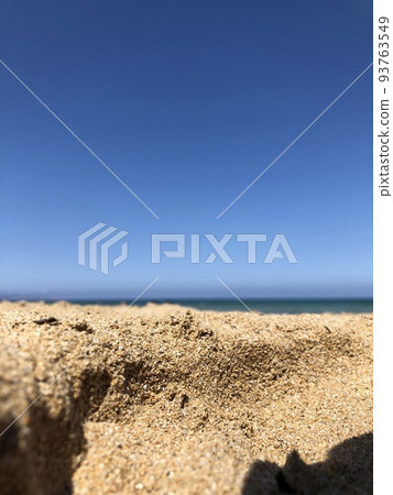 Brown sands near seashore with blue sky in Sicily. Blue and yellow summer colours, abstract concept.  93763549