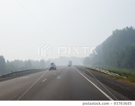 haze on highway from burning forest smoke haze on highway from burning forest smoke 93763685