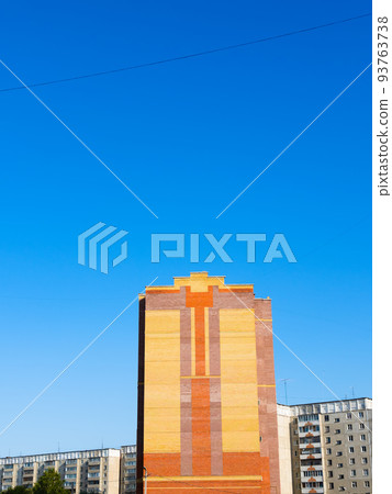 blue sky over orange house in residential district 93763738