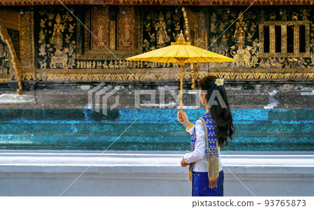Asian woman wearing laos traditional at Wat Xieng Thong (Golden City Temple) in Luang Prabang, Laos. 93765873