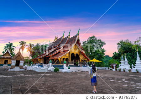 Asian woman wearing laos traditional at Wat Xieng Thong (Golden City Temple) in Luang Prabang, Laos. Asian woman wearing laos traditional at Wat Xieng Thong (Golden City Temple) in Luang Prabang, Laos. 93765875