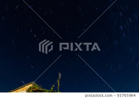 Star trails around North star on the night sky. 93765964