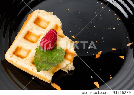 Leftover breakfast on a plate. Stale food. Waffle scraps. 93766279