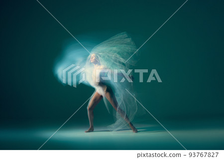 Freedom. Beautiful and graceful ballet dancer dancing with white transparent cloth, isolated on cyan color background. Art, fantasy, flexibility, inspiration concept. 93767827