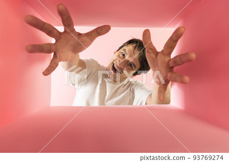 Emotive, smiling man looking inside carton box with hands, expressive face Emotive, smiling man looking inside carton box with hands, expressive face 93769274