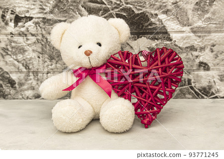White Teddy bear with red heart on grey wall background White Teddy bear with red heart on grey wall background 93771245