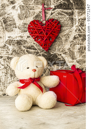 White Teddy bear with red heart and gift box on grey wall background White Teddy bear with red heart and gift box on grey wall background 93771247