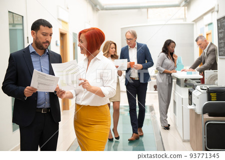 Business team of men and women in an office analyzing the evolution of the company Business team of men and women in an office analyzing the evolution of the company 93771345