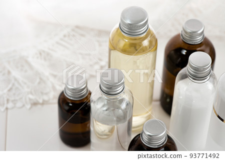 Various types of cosmetic containers arranged on white tiles 93771492