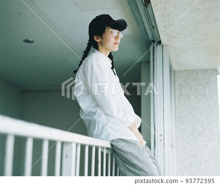 woman sitting on railing woman sitting on railing 93772395