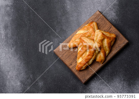 Delicious fresh cornmeal pastries with homemade cheese on a wooden cutting board 93773391