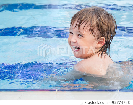 Toddler floats in paddling pool. Teaching children to swim from early childhood. Sport, active lifestyle and physical development. 93774768