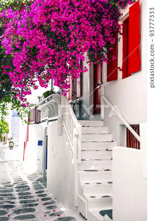 Charming typical floral streets of greek islands. Mykonos, Cyclades. 93777333
