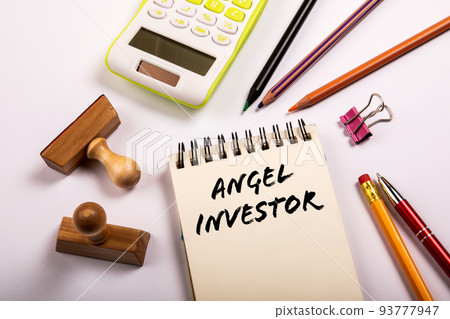 Angel investor. Stationery on a white office table 93777947