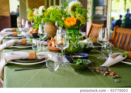 beautiful setting of a large table with flowers. beautiful setting of a large table with flowers. 93778003