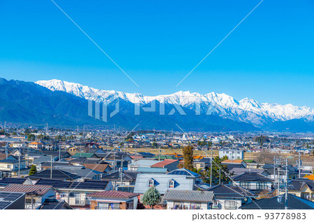 The city of Azumino in early winter with fine weather and the Northern Alps covered with snow [Nagano Prefecture] 93778983